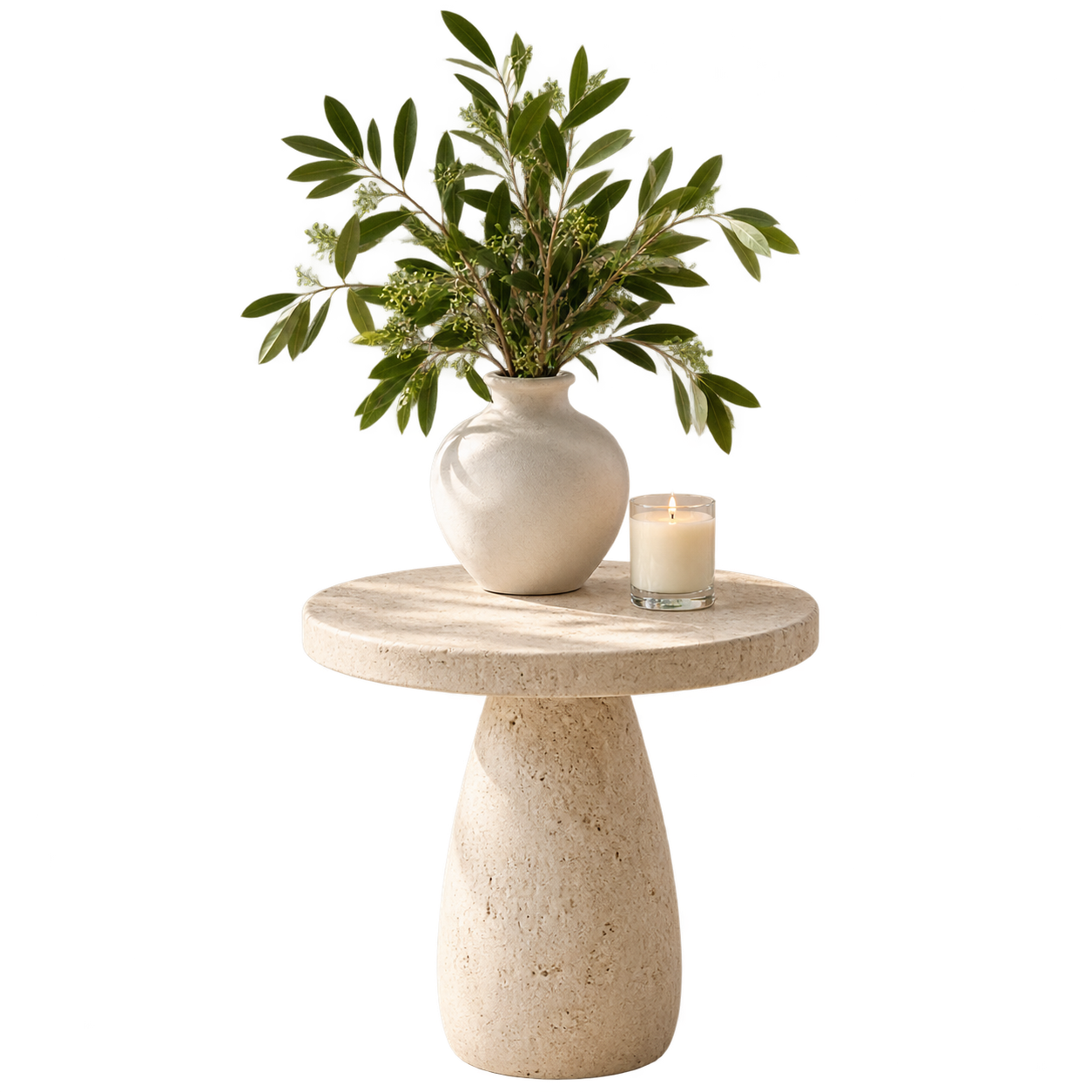 Leafy stems in a cream ceramic vase beside a small candle.